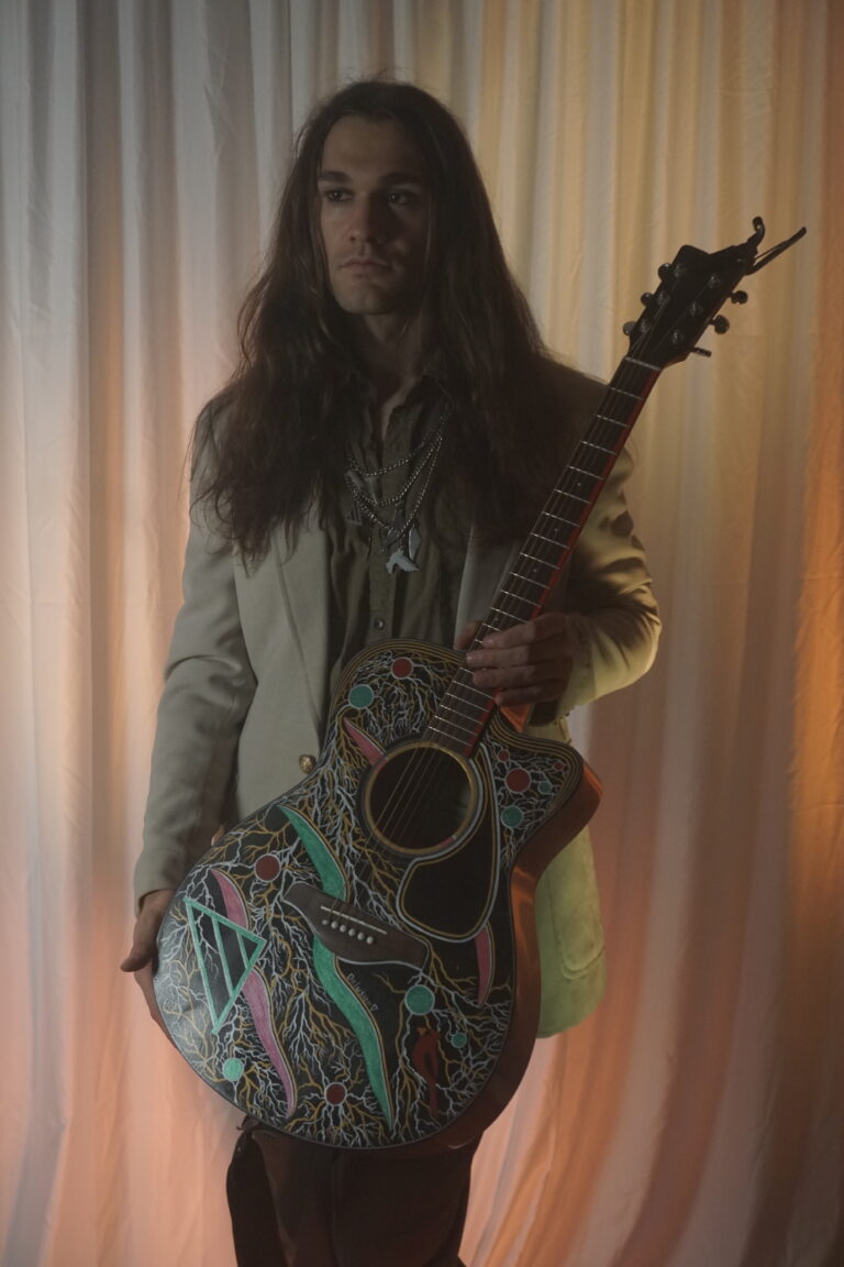 Andrew Brooks and his guitar, "Delusion"